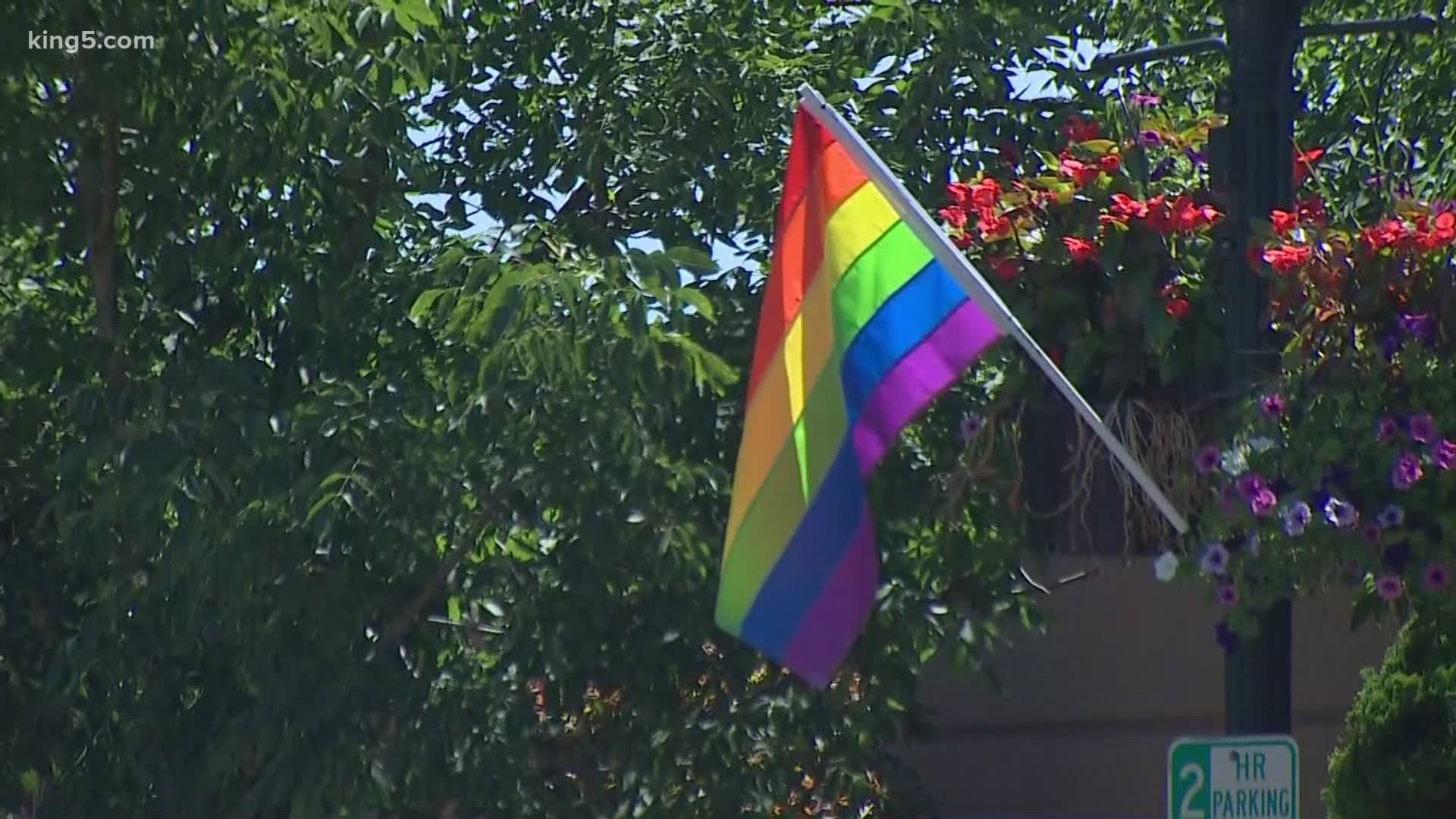 The community rallied together to replace about 38 Pride flags that were stolen from the light poles in downtown Burien last weekend.
