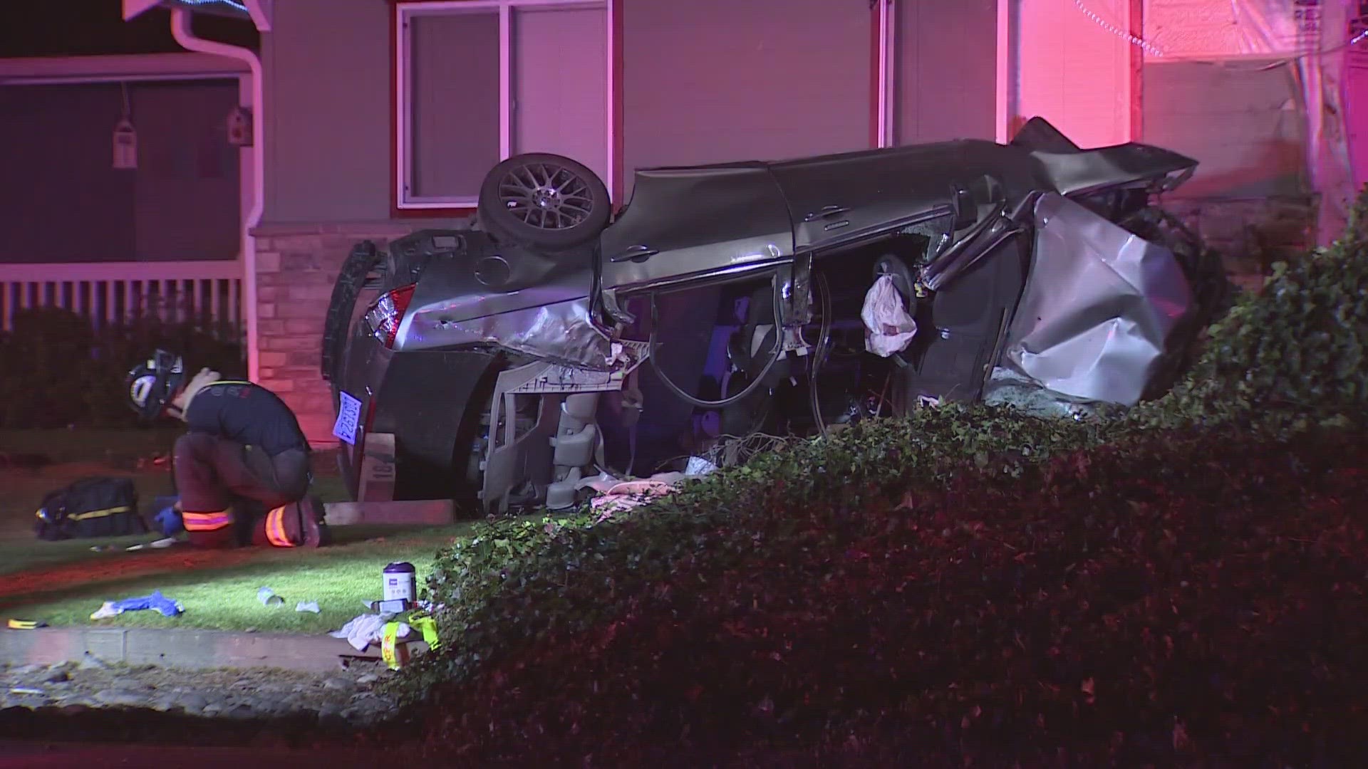 A woman has died and a man is in critical condition after a car ran into a house in Spanaway