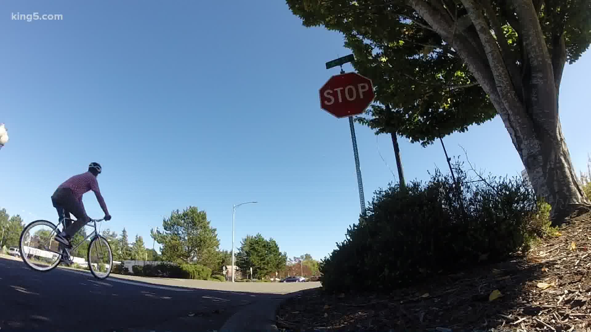 A new law allows bicyclists to roll through stop signs, but they must still give the right-of-way to vehicles at intersections.