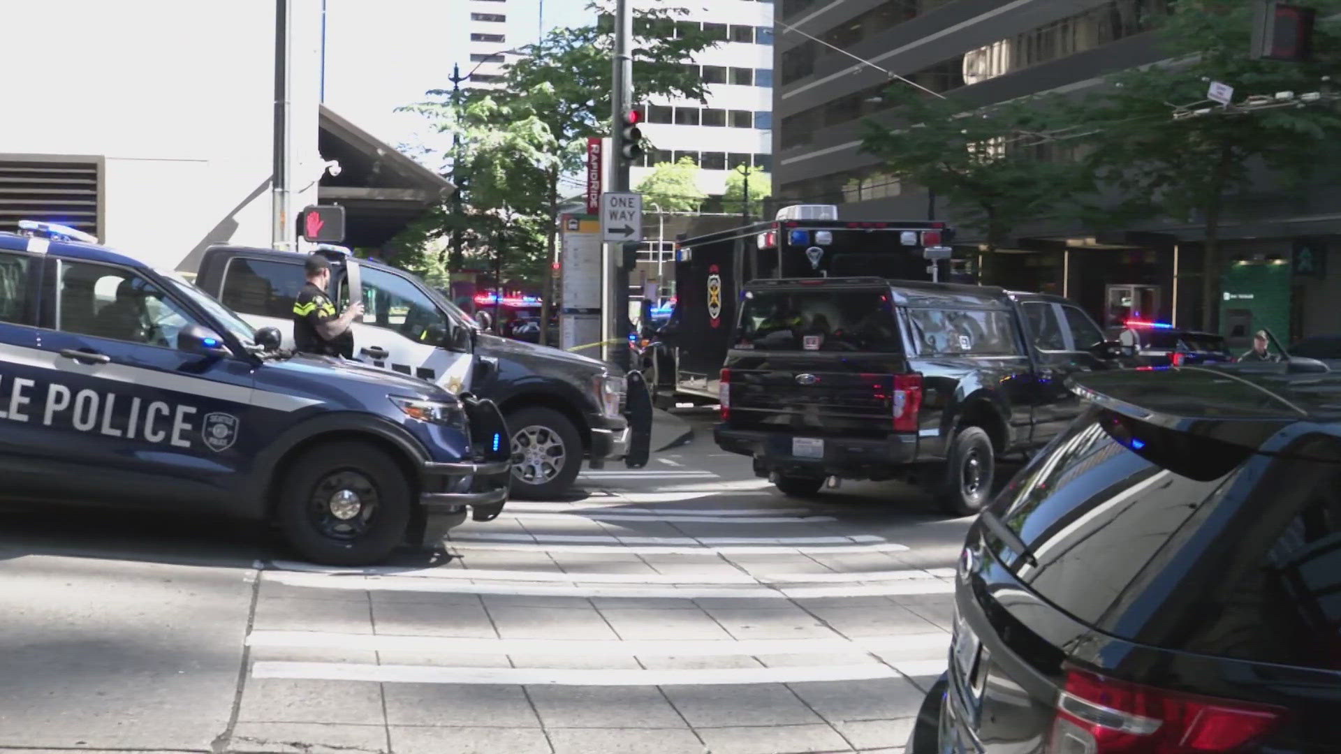 ​Seattle police say the woman entered the building on Third Avenue and was pointing a gun to her chest.