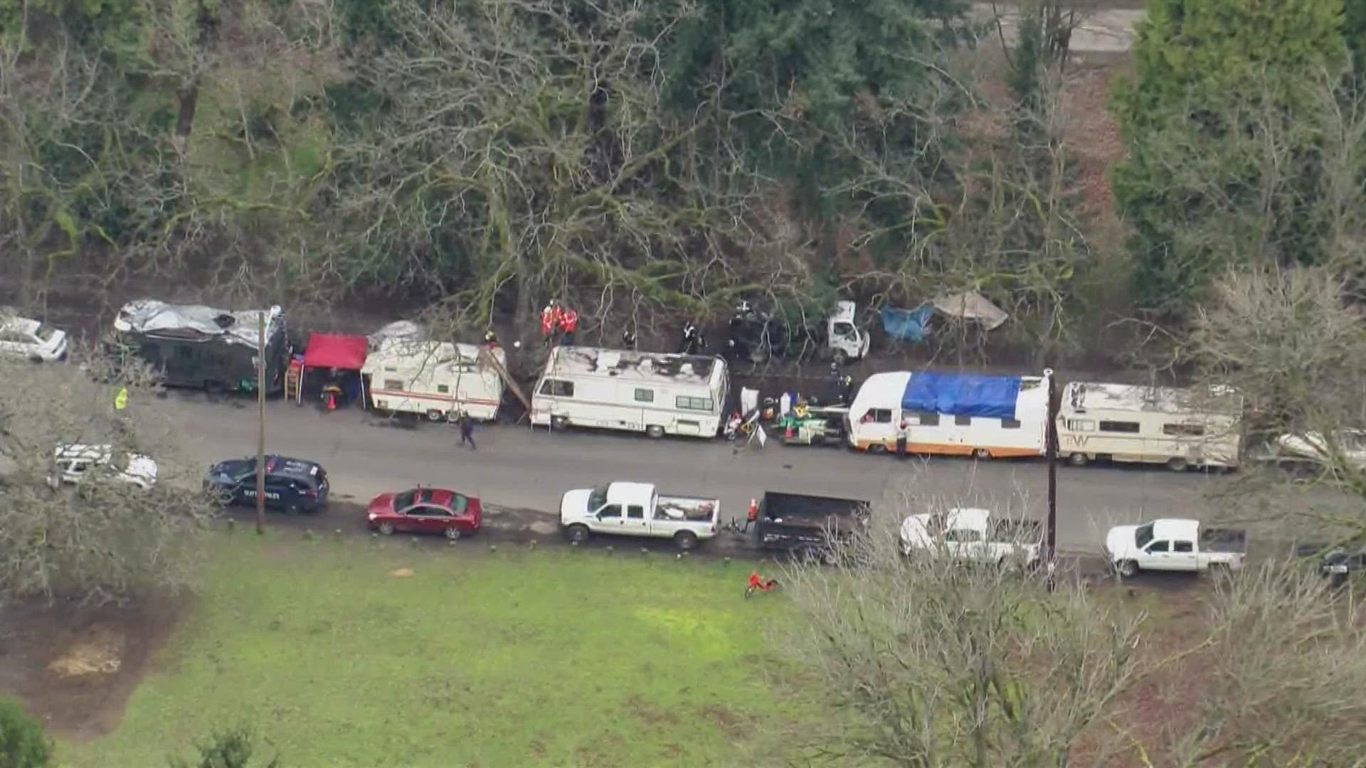 Crews with the city of Seattle began to clear tents and RVs from a homeless camp at Green Lake Park Monday morning.