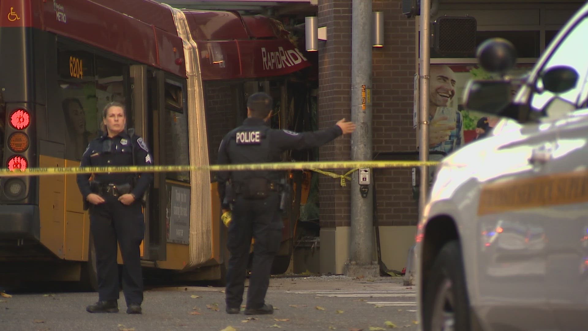 A vehicle collided with a bus, which then crashed into a building near 5th Avenue and Battery Street on Saturday afternoon, Seattle Fire says