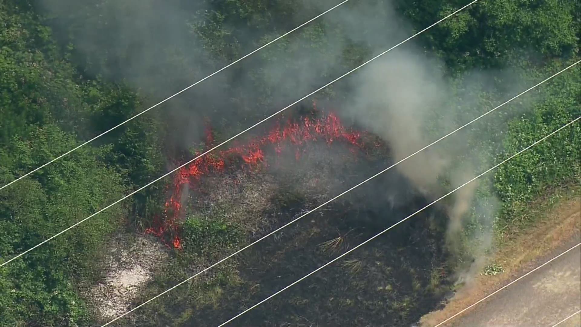 A transformer explosion caused a brush fire near homes and under power lines in Redmond on Monday afternoon. Aerials from SkyKING show how close the flames came to a neighborhood and network of power lines.