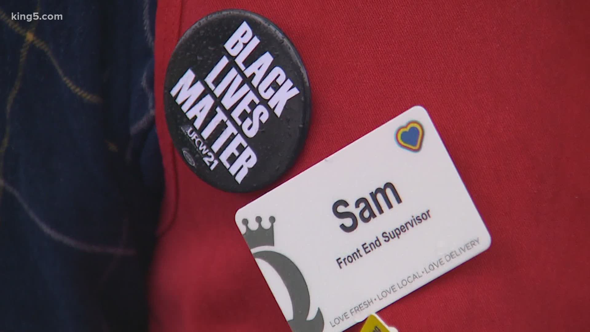 Employees at QFC and Fred Meyer stores are saying a ban on “Black Lives Matter” buttons violates federal labor law and their union contract.