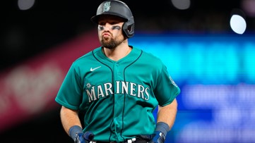 Seattle Mariners players embrace Home Run Trident