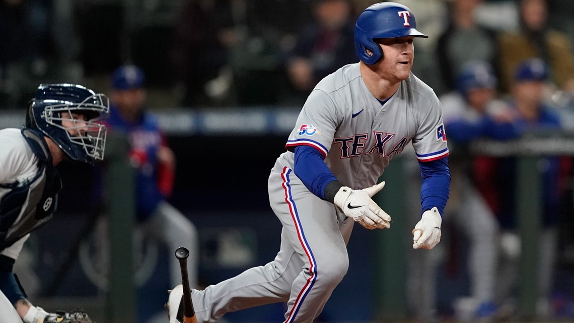 Kole Calhoun of the Texas Rangers runs the bases after hitting a