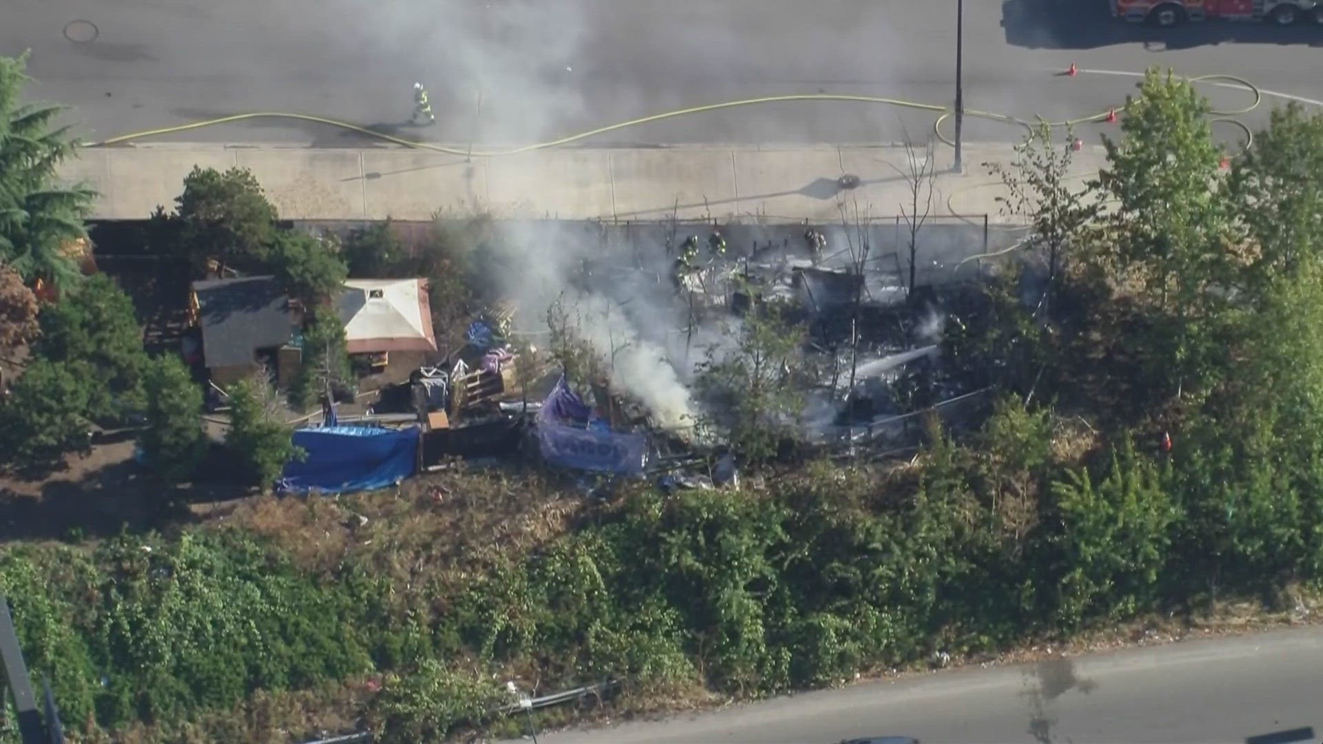 Aerials: Crews battle fire at encampment in Seattle | king5.com