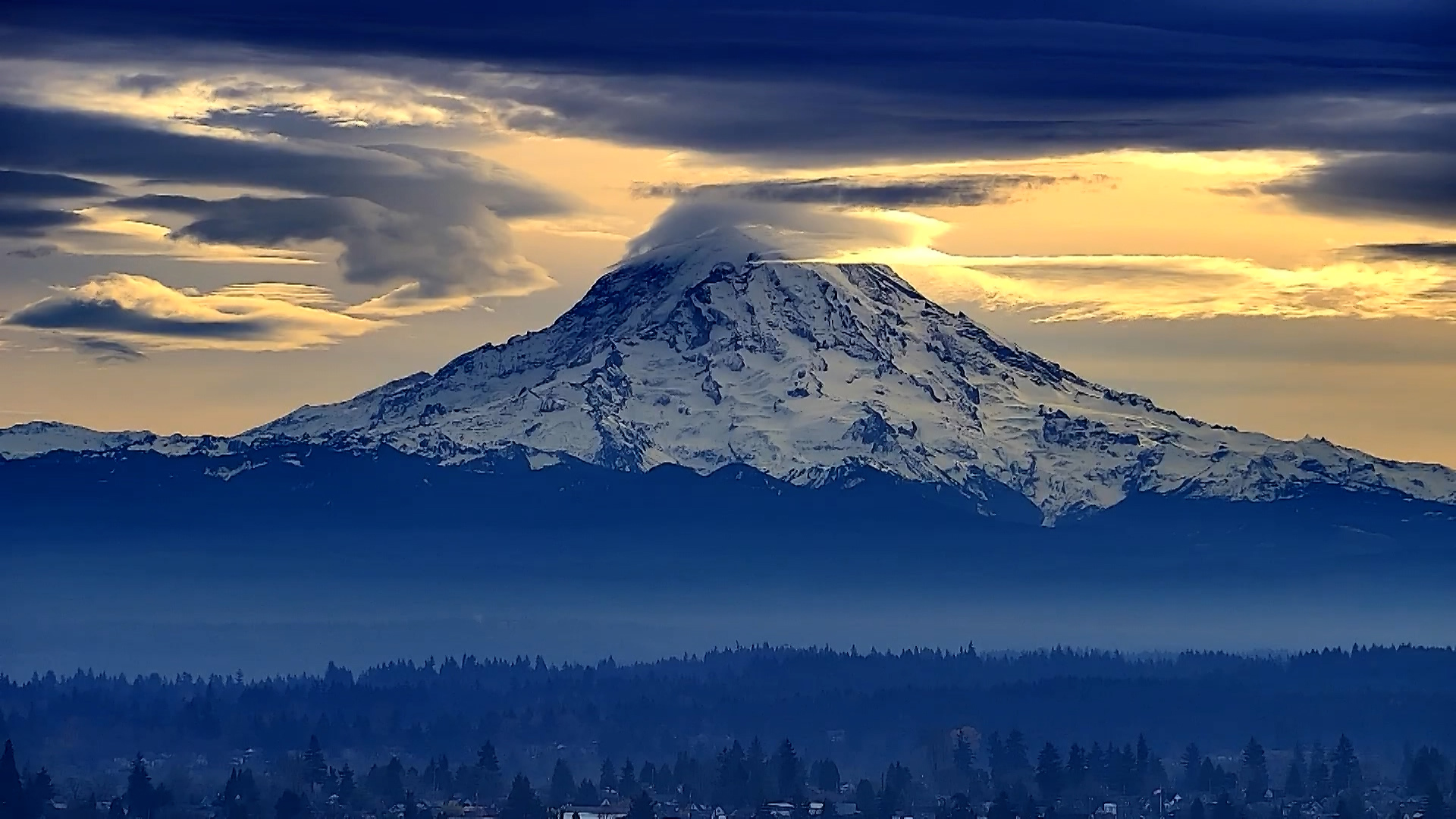 A lenticular cloud surrounds the top of Mount Rainier