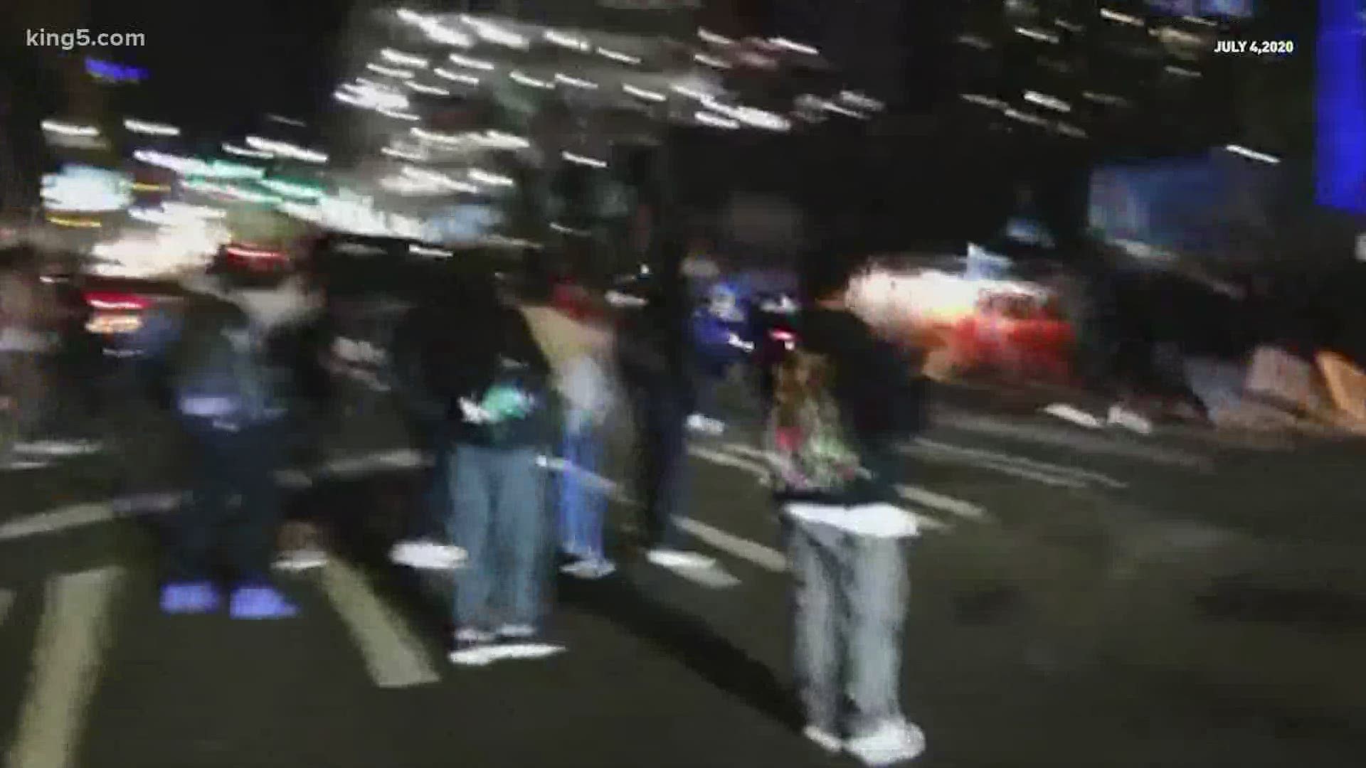 Video shows a car driving through a crowd of protesters on Capitol Hill after midnight on July 4. The incident is unrelated to a deadly crash on I-5.