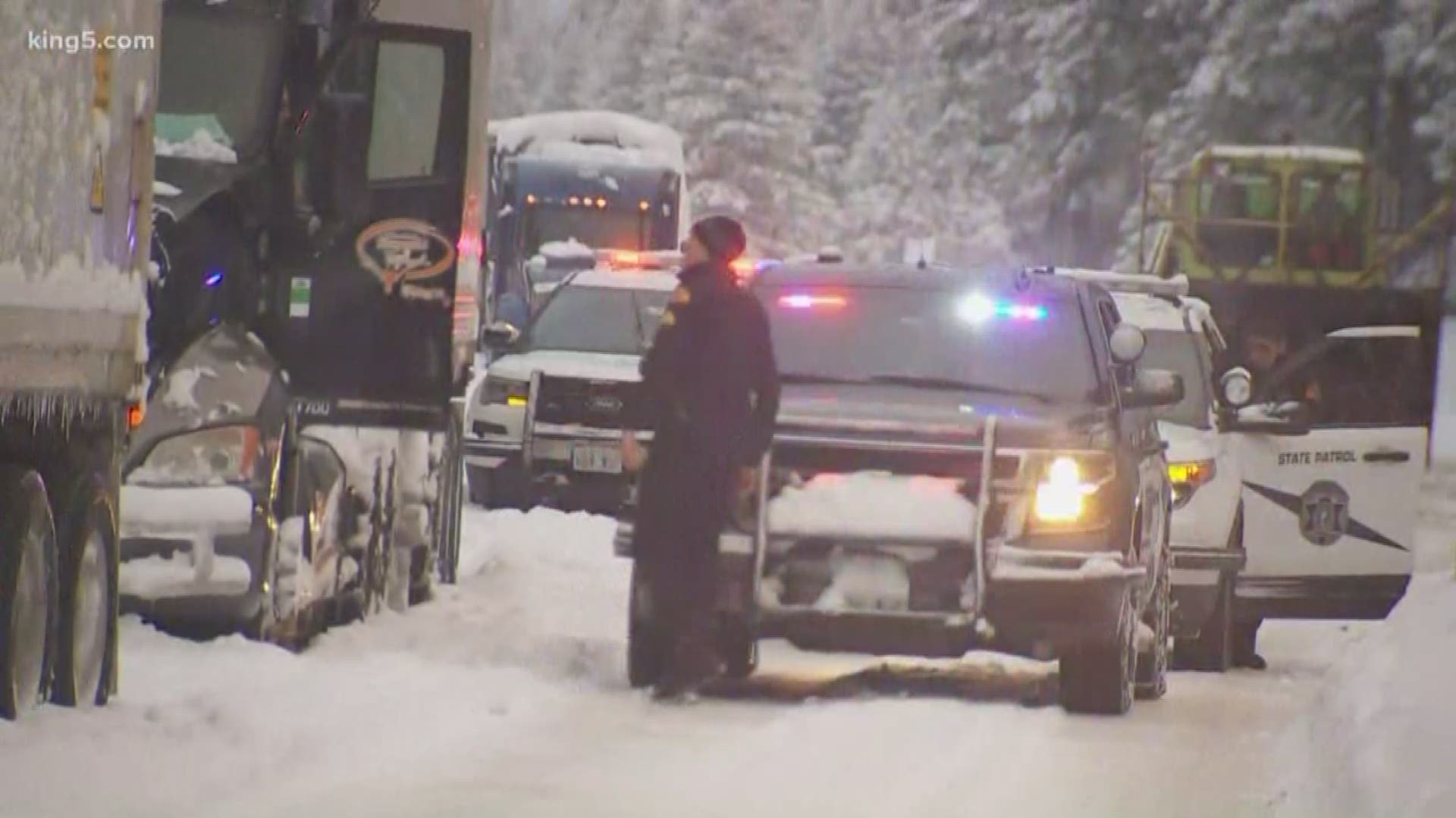 The Washington State Patrol and Washington State Department of Transportation are leading a caravan of semi trucks off Snoqualmie Pass while the pass is closed by deep snow and treacherous conditions. KING 5's Michael Crowe reports.