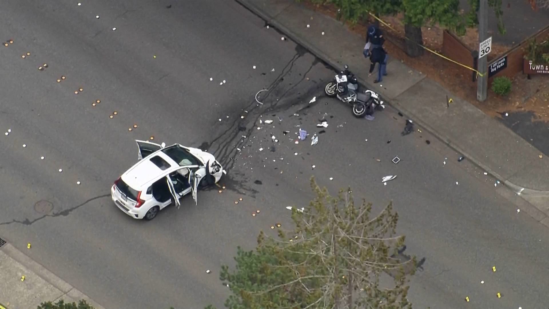 A crash between a car and a motorcycle shut down Bellevue Way between Southeast Wolverine Way and Southeast 6th Street on Monday.