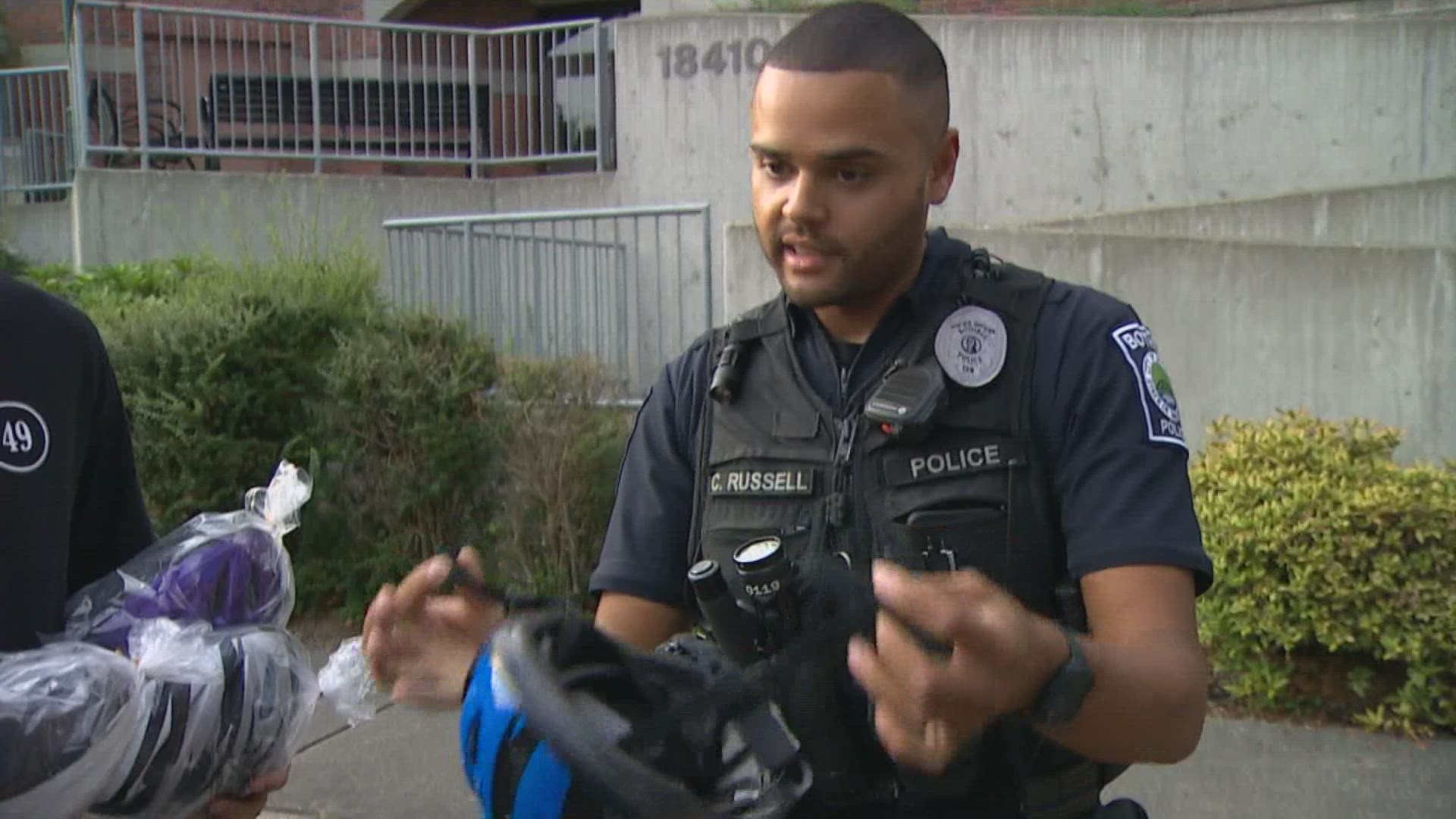 A Bothell police officer gave out free bicycle helmets with the help of a man whose story helped generate state funding for helmets.