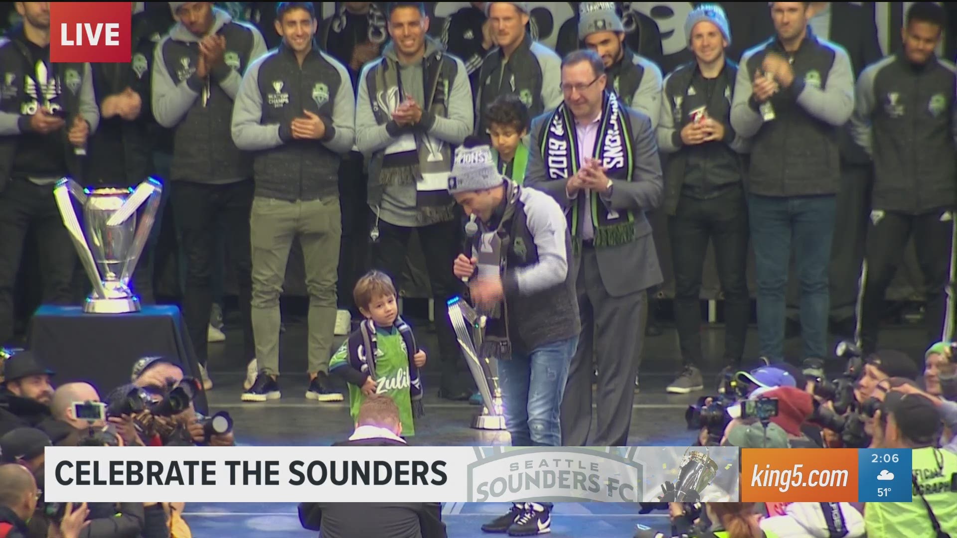 Seattle Sounders team captain Nicolás Lodeiro dances with his son at championship rally. king5.com