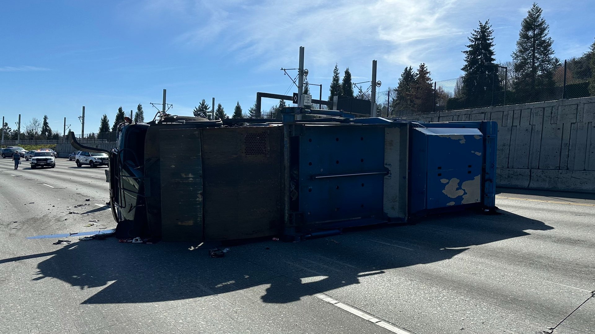 The driver of the truck was injured after it tipped over on the highway, according to the Washington State Patrol.