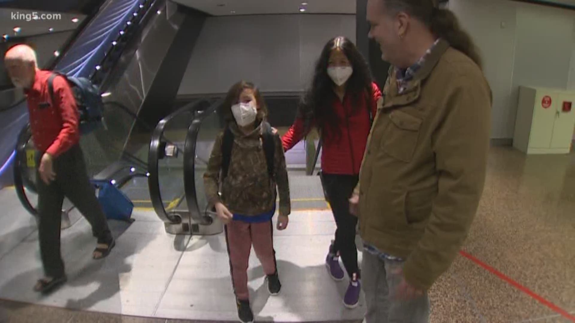A 9-year-old Bellevue boy was reunited with his father in Seattle after spending two weeks in China amid the Wuhan coronavirus outbreak.