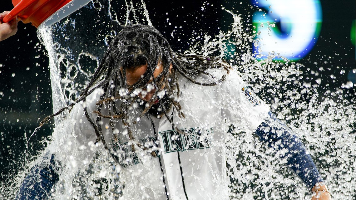 Seattle Mariners' J.P. Crawford holds a trident after hitting a