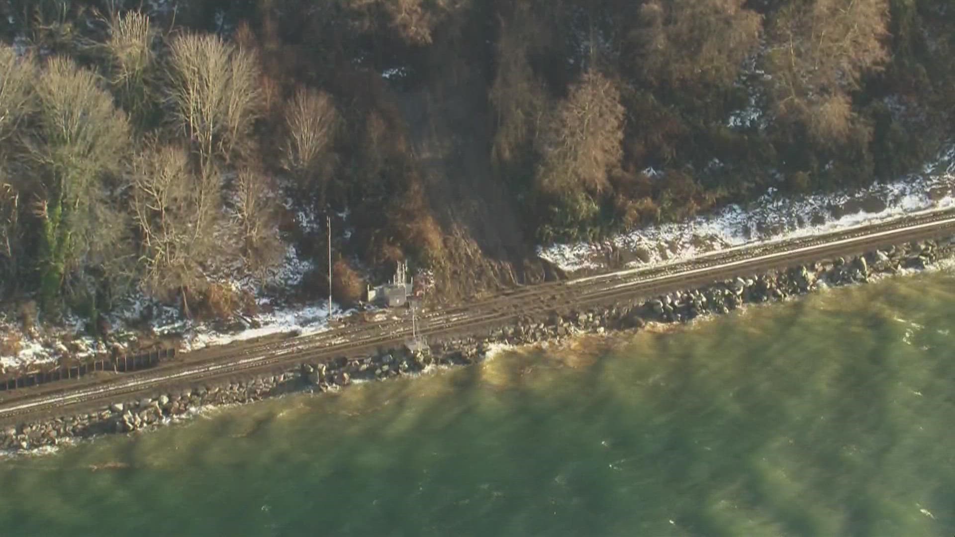 A landslide is covering train tracks north of Edmonds Monday and is impacting train services between Seattle and Everett.