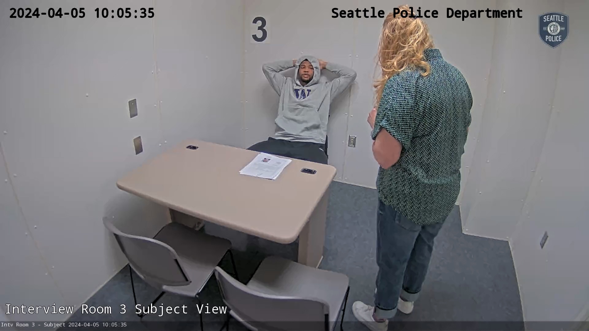 Newly released footage shows UW football player Tylin "Tybo" Rogers learning of the charges against him at a Seattle PD precinct