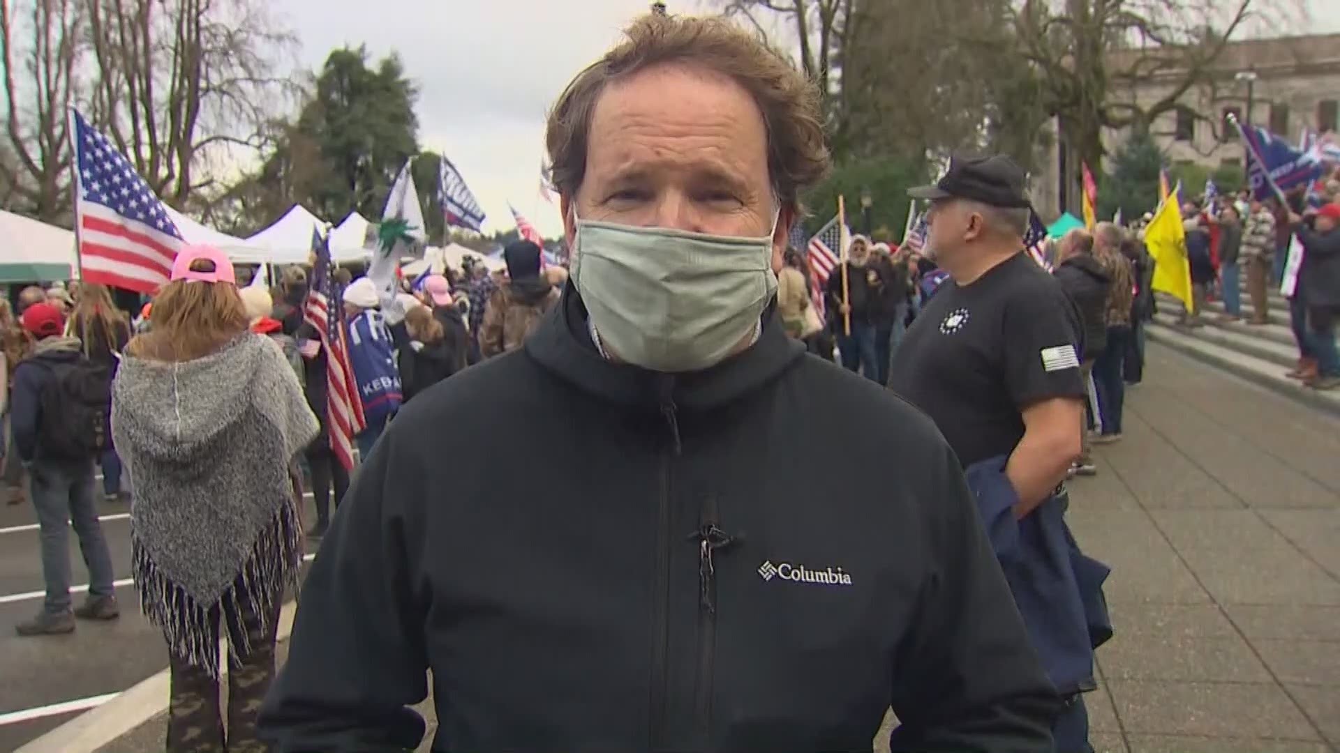 A peaceful pro-Trump rally outside of the State Capitol building in Olympia stands in stark contrast to the chaos in Washington D.C.