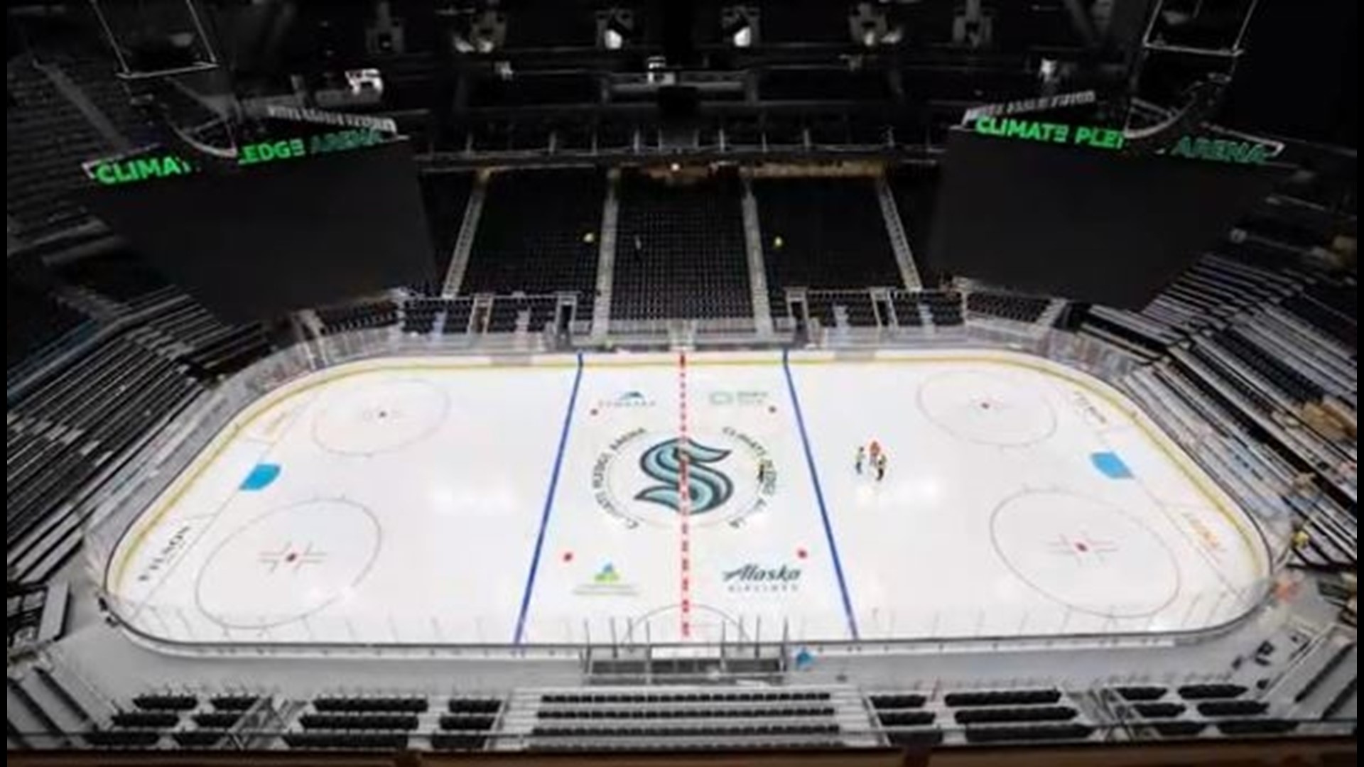 Seattle Kraken fan awaits seat assignment during finishing touches on