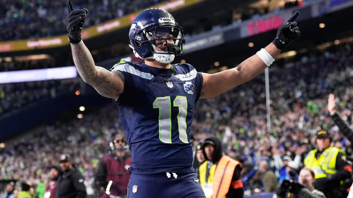 Seattle Seahawks wide receiver Jaxon Smith-Njigba (11) celebrates his touchdown catch during the first half of the NFC Championship NFL football game.