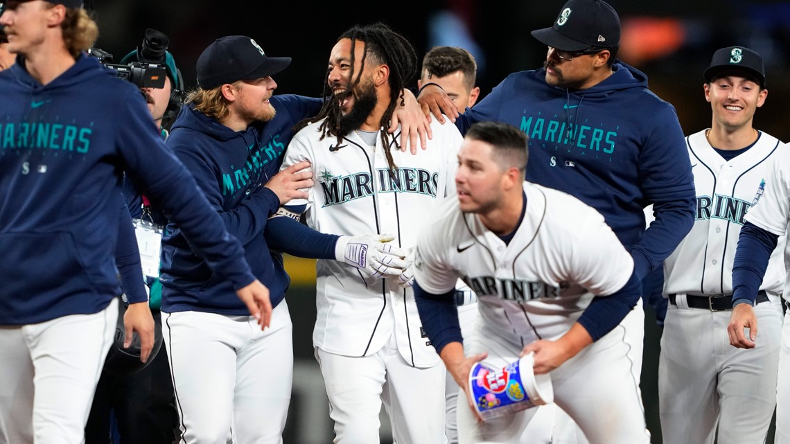 Seattle Mariners players embrace Home Run Trident