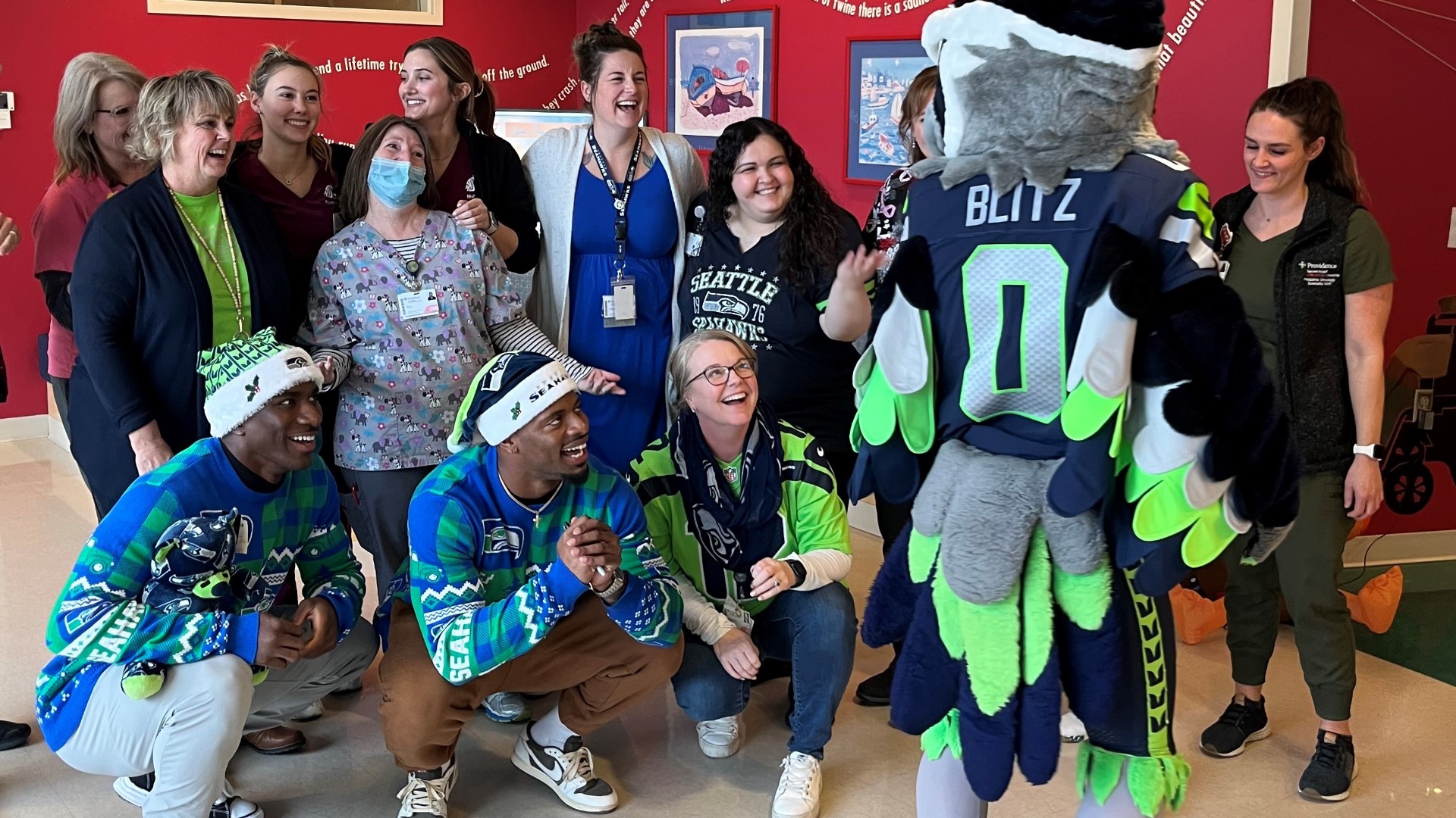 Seattle Seahawks players and mascot Blitz stopped by the children's hospital to bring joy during the holiday season.