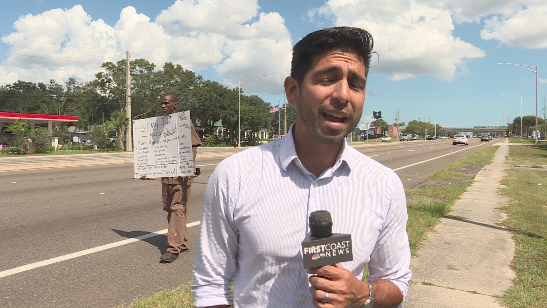 The story behind a viral photo of a man holding a handwritten sign on the corner of Beach Blvd.